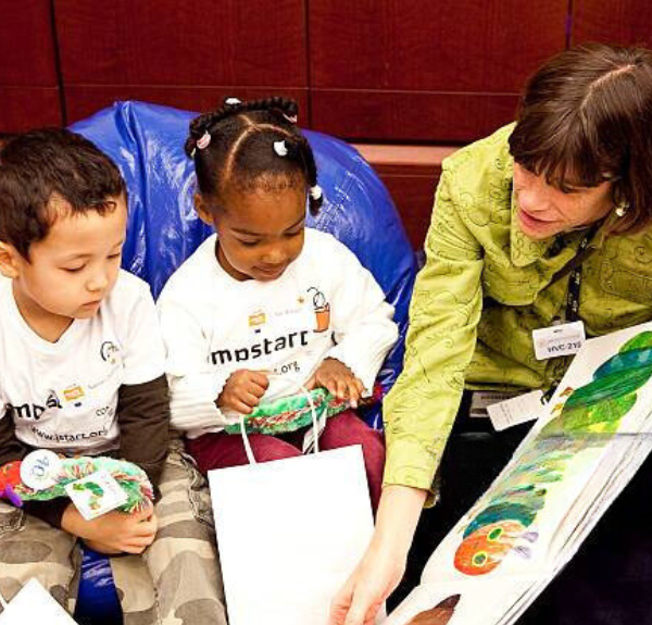 Photo of Amanda reading with children