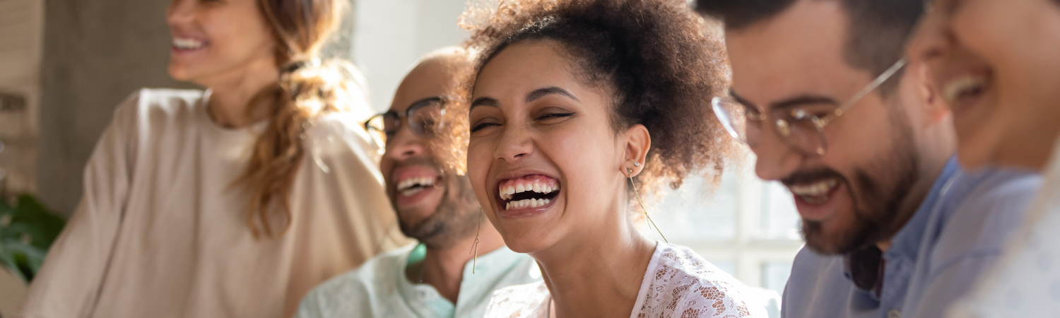 Image young adults laughing in an office setting