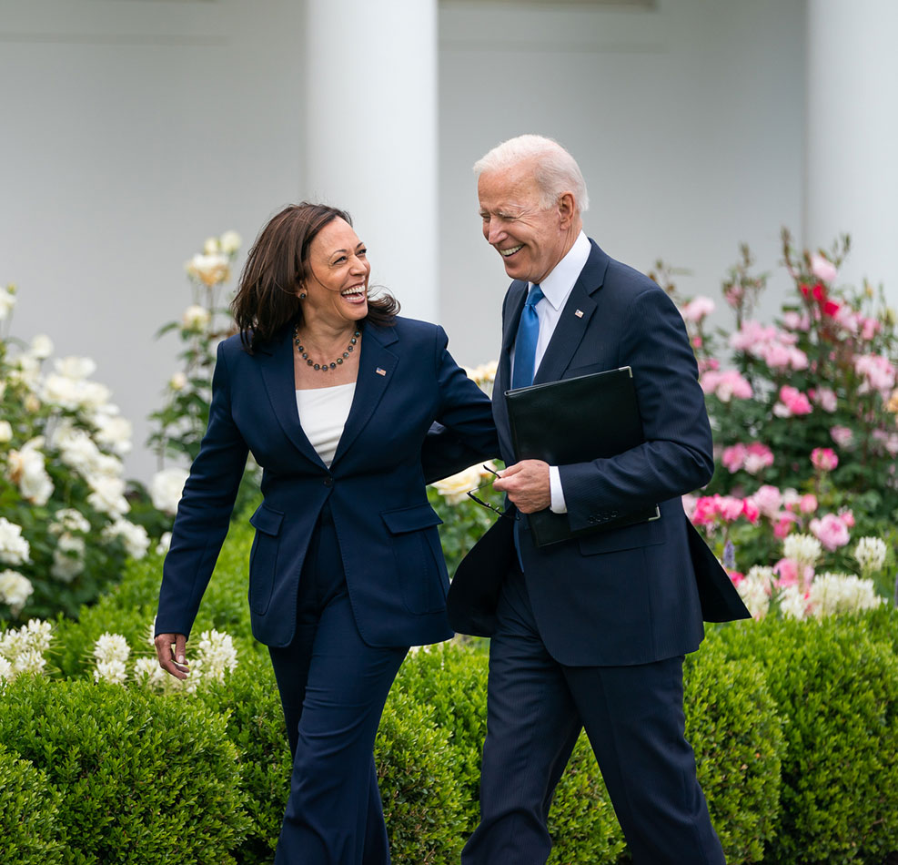 President Joe Biden and Vice President Kamala Harris walk together by the White House.