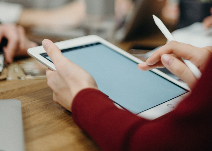 Person holding a tablet device.