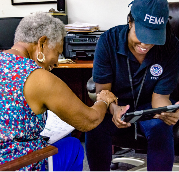 FEMA team member assisting person.