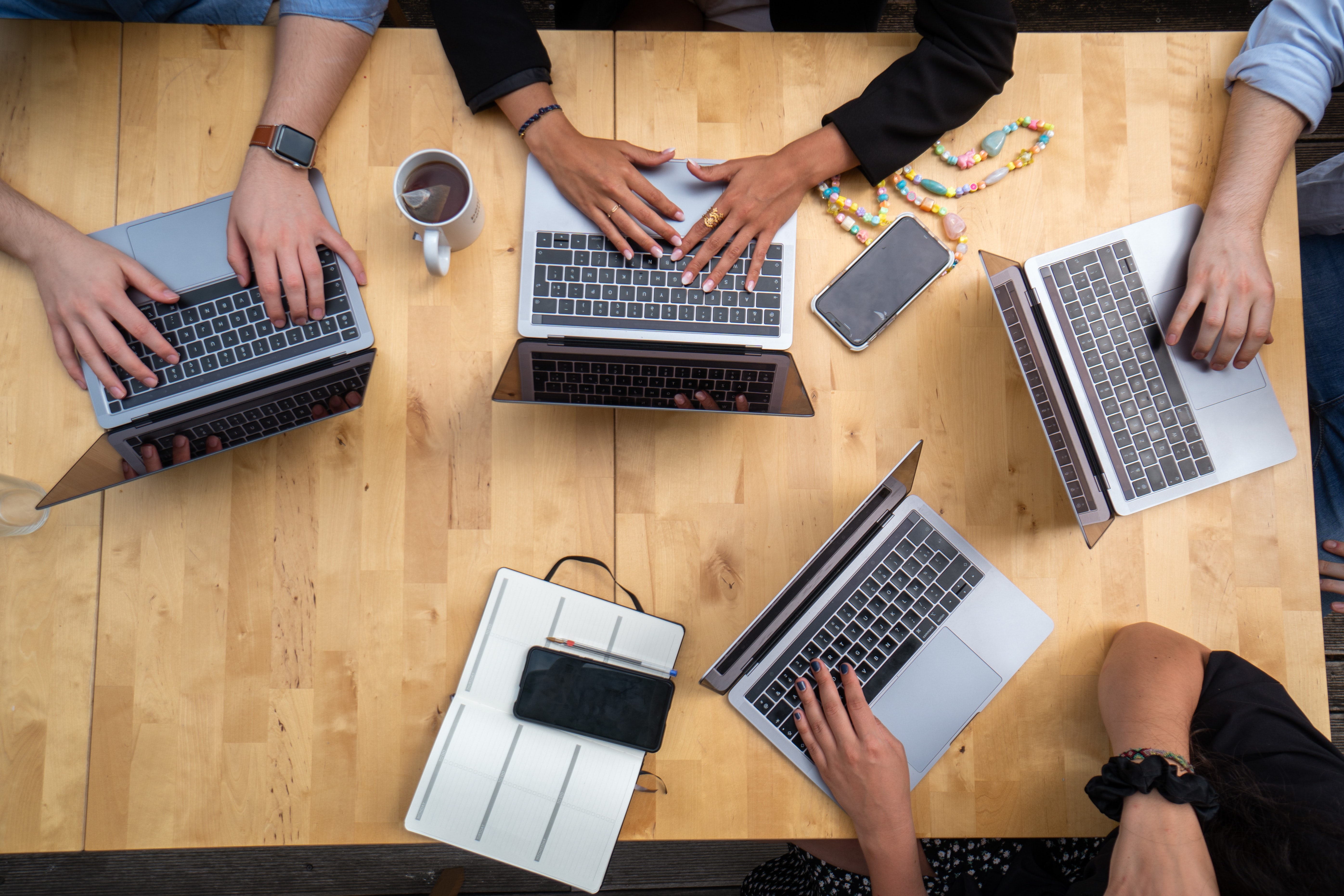 Photo of people working together on computers